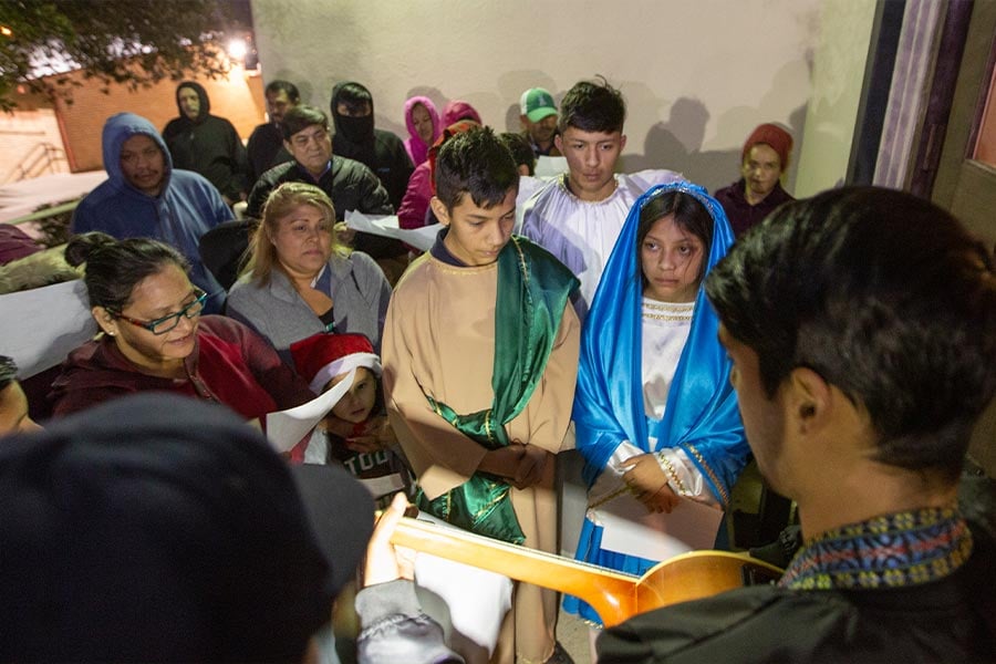 Siblings Reymundo Juarez( 14 as Joseph), Francisco Juarez (15 as an Angel) and Samantha Juarez (13 as Mary) are turned away at the door of the inn during the traditional celebration of Las Posadas at Holy Name of Jesus Catholic Church in this 2019 file photo. (NTC/Rodger Mallison)