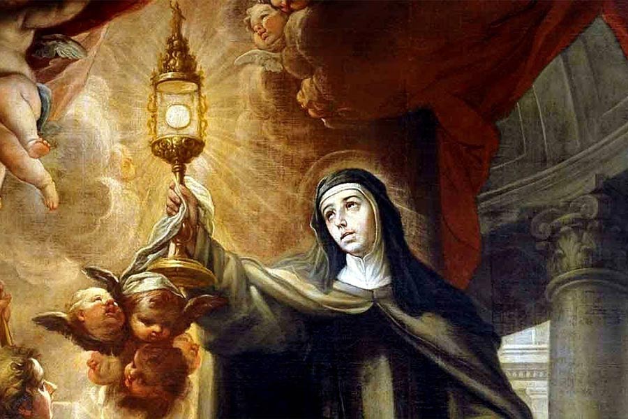 Saint Clare of Assisi holds up the Blessed Sacrament.