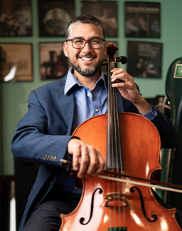 David Fernandez poses with his cello, which is 21 years old. (NTC/Juan Guajardo)