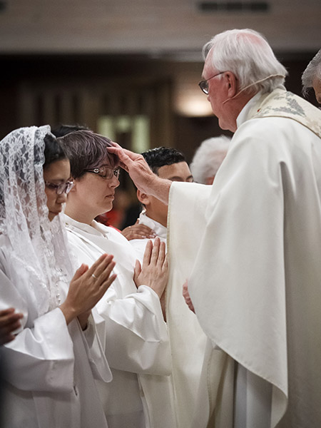 Father John Swistovich confirms Cristina Almaden during an Easter Vigil Mass.
