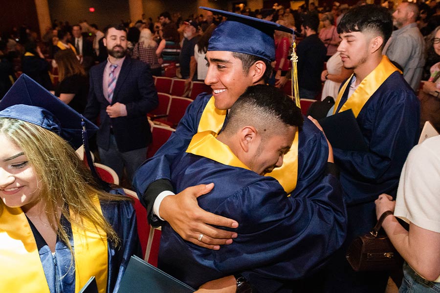 Graduates Emmanuel Rodriguez, left, and Cesar Gonzalez, embrace after receiving their diplomas during the Cristo Rey Fort Worth College Prep commencement ceremony comes to an end. (NTC/Ben Torres)