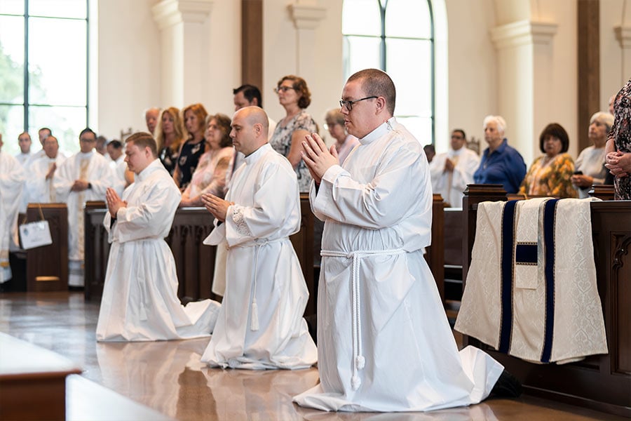 Brandon LeClair kneels before the altar during the Rite of Ordination at St. Philip the Apostle Church in Flower Mound. (NTC/Juan Guajardo)