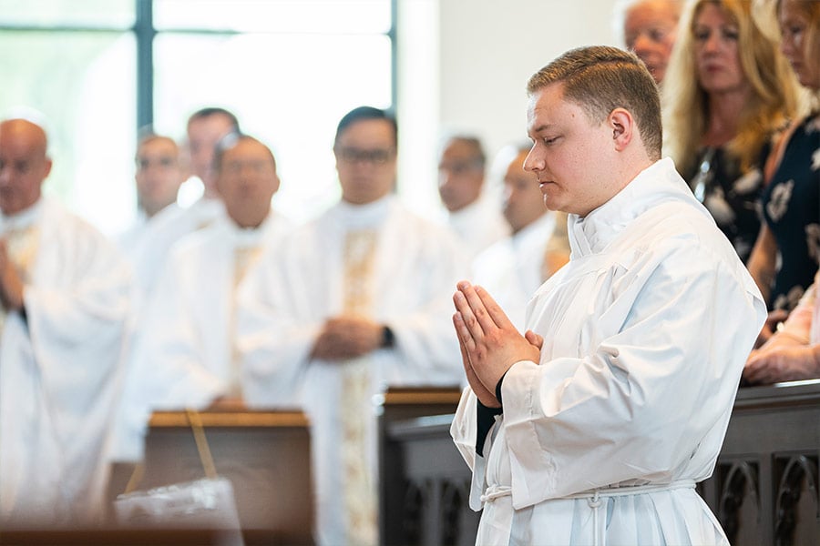 Transitional diaconate candidate Austin Hoodenpyle kneels before the altar during the Rite of Ordination at St. Philip the Apostle Church on May 21, 2022. (NTC/Juan Guajardo)