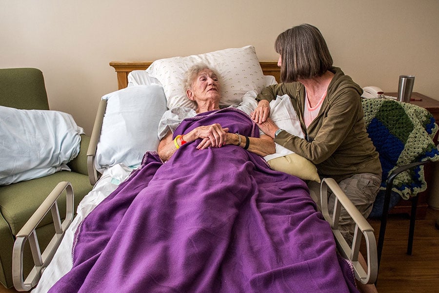 woman at bedside of patient