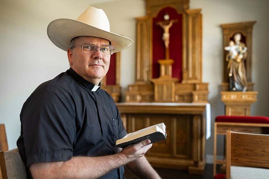Father Kyle holds Bible