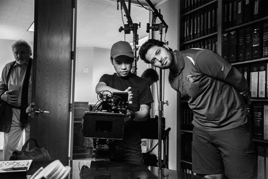 Filmmaker Rob Smat (right) sizes up a camera angle on set. (Courtesy photo)