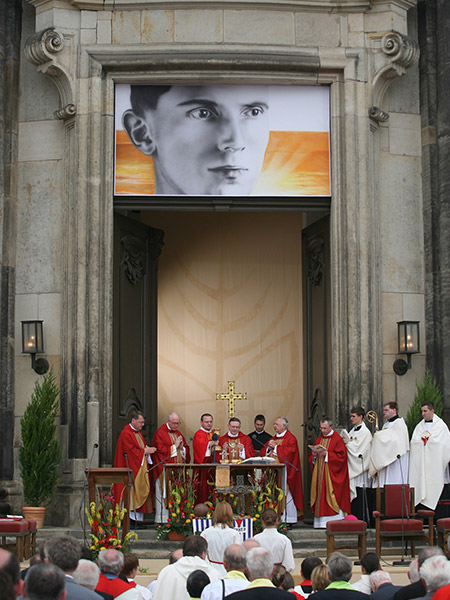 An image of Father Alois Andritzki hangs above the altar during his Mass of beatification in Dresden, Germany