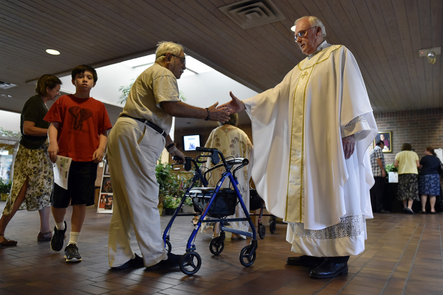 Fr. John Swistovich greets parishioners