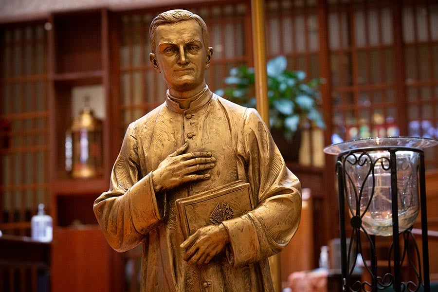 A statue of Father Michael McGivney, the founder of the Knights of Columbus, stands before the altar at St. Andrew Catholic Church.
