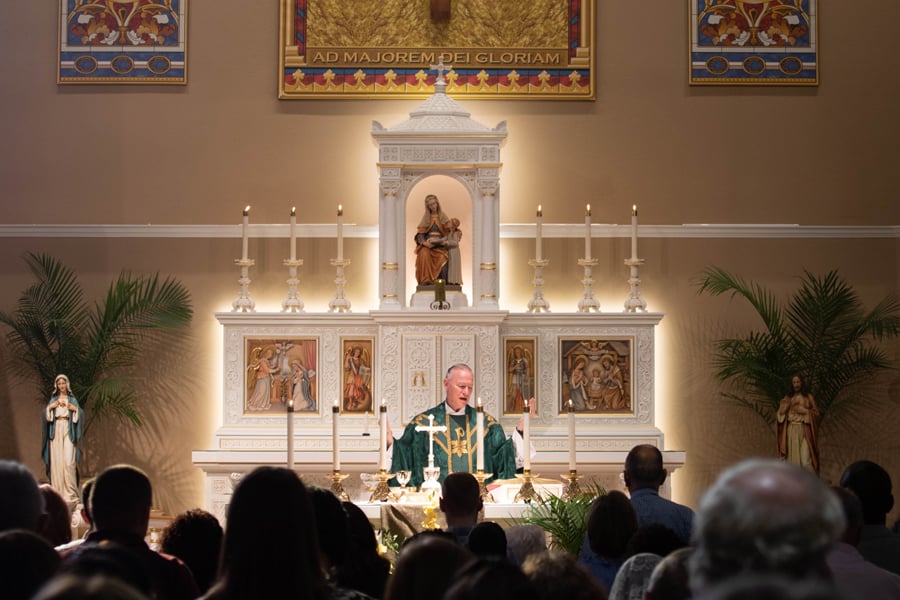 Father Mel Besselieu celebrates Mass