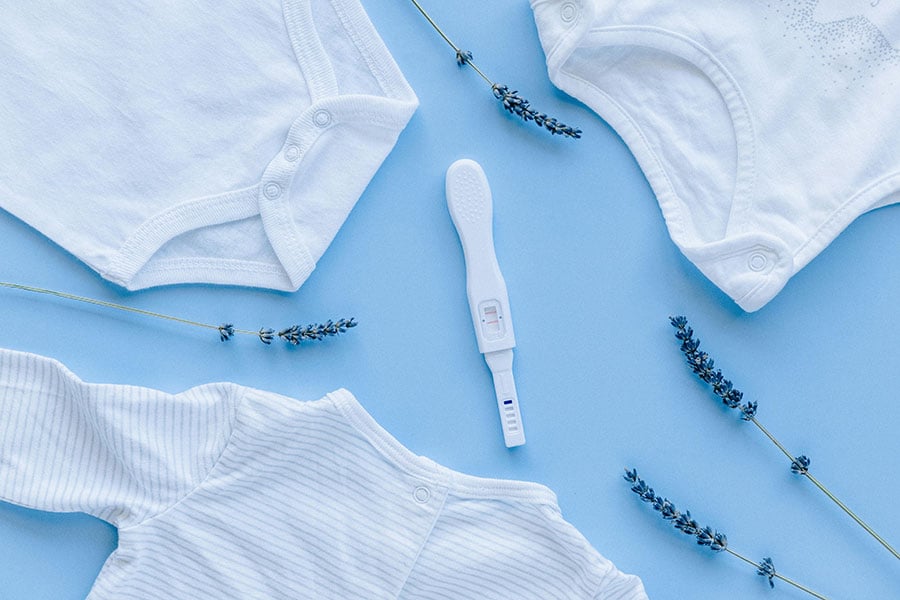 onesies and a pregnancy test