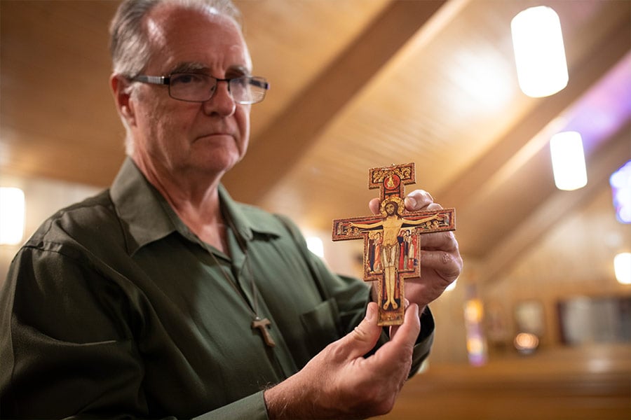Bob Wittman holds his newly-presented San Damiano Crucifix after his profession in the St. Clare Fraternity of the Secular Franciscan Order on September 12, 2021 at Saint Francis Village in Crowley. (NTC/Rodger Mallison)