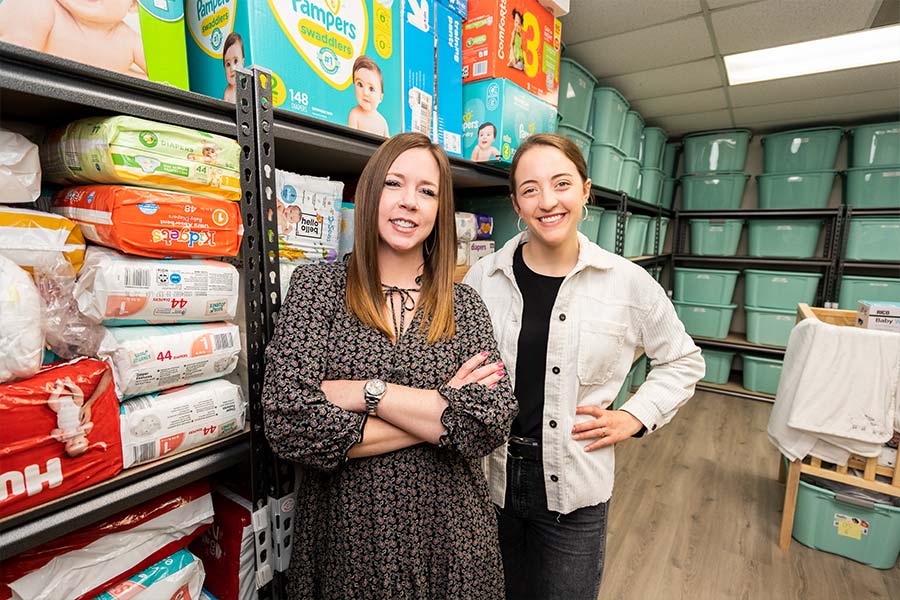 Allison Moore, director of the Gabriel Project, is shown with Emma Bouillion, coordinator of young adult outreach at St. Elizabeth Ann Seton, at the parish’s Gabriel Project supply closet. (NTC/Juan Guajardo)