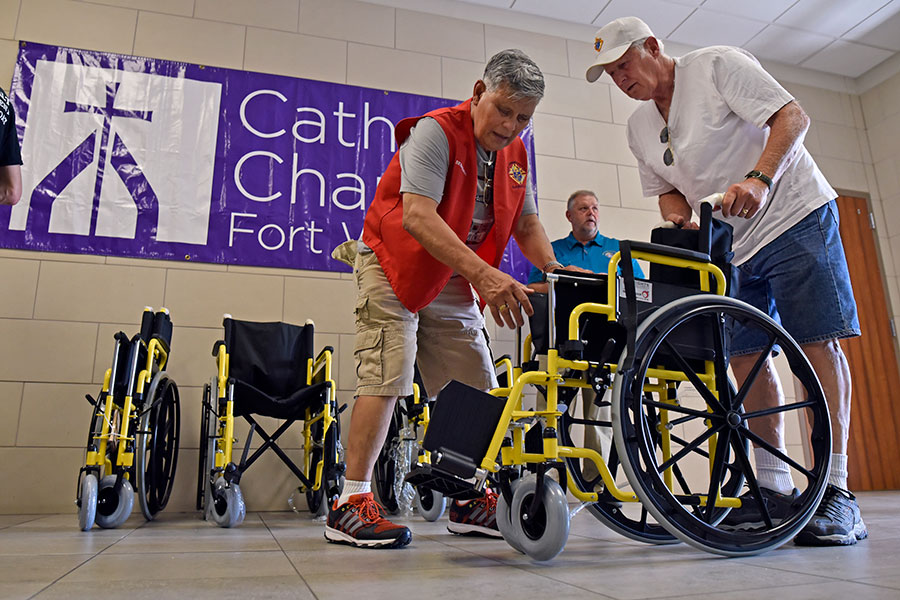 Two men unfold wheelchair