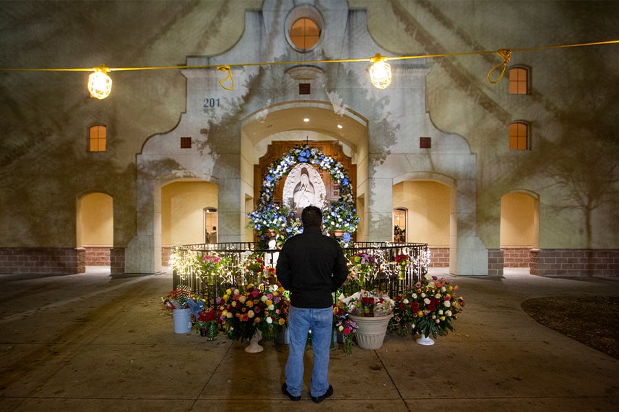 A worshipper pauses outside the church prior to a Mass on the Feast of Our Lady of Guadalupe at Immaculate Heart of Mary Church in Fort Worth December 12, 2018. (NTC/Rodger Mallison)