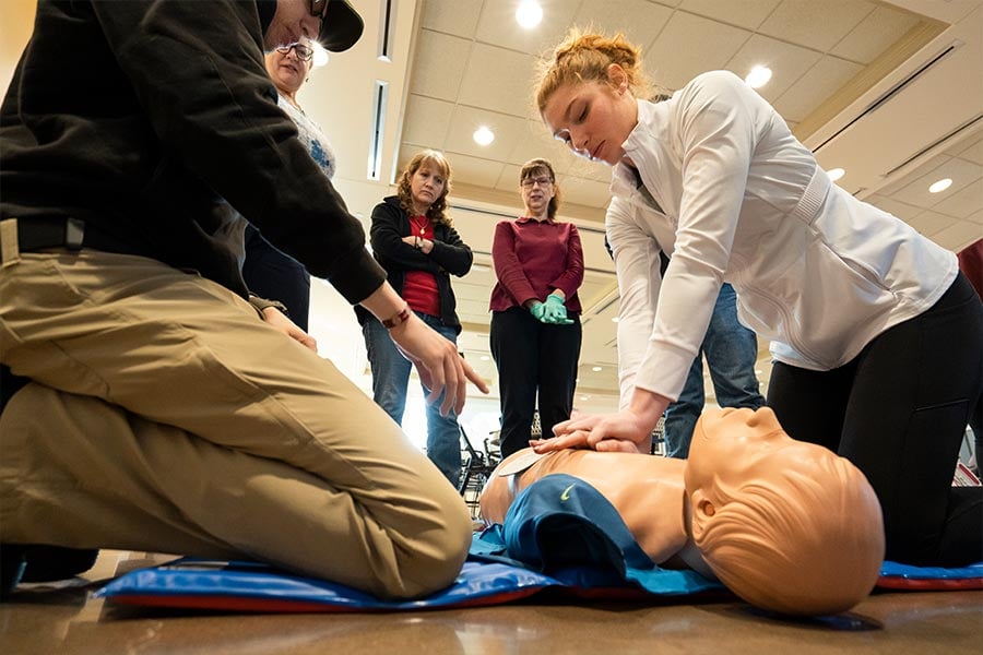 Bethany Capps, a parishioner and member of the medical Guardians, practices compressions and CPR during a training. Guardian Ministers at St. Philip the Apostle Parish learned adult and pediatric CPR, AED, and first aid during a class led by medical Guardian volunteers on March 26, 2022. (NTC/Juan Guajardo)