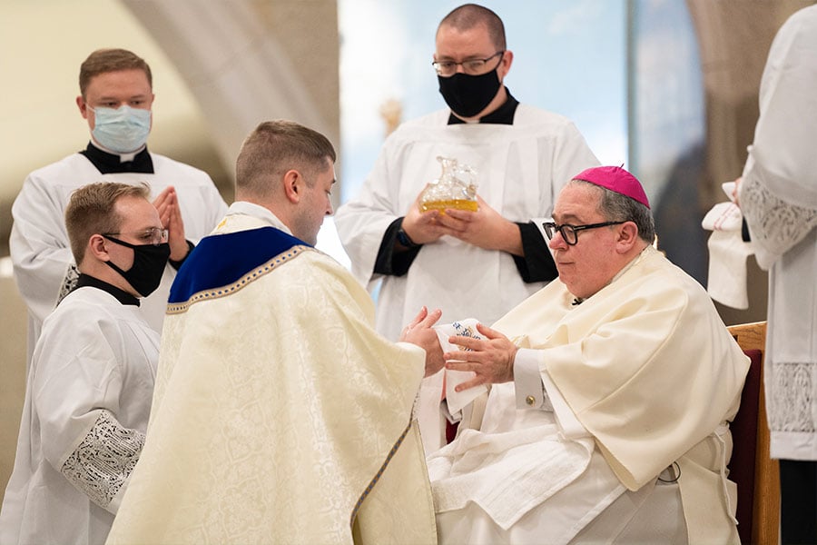 Bishop Michael Olson anoints the hands of the newly ordained Father Thomas Jones. (NTC/Jayme Donahue)