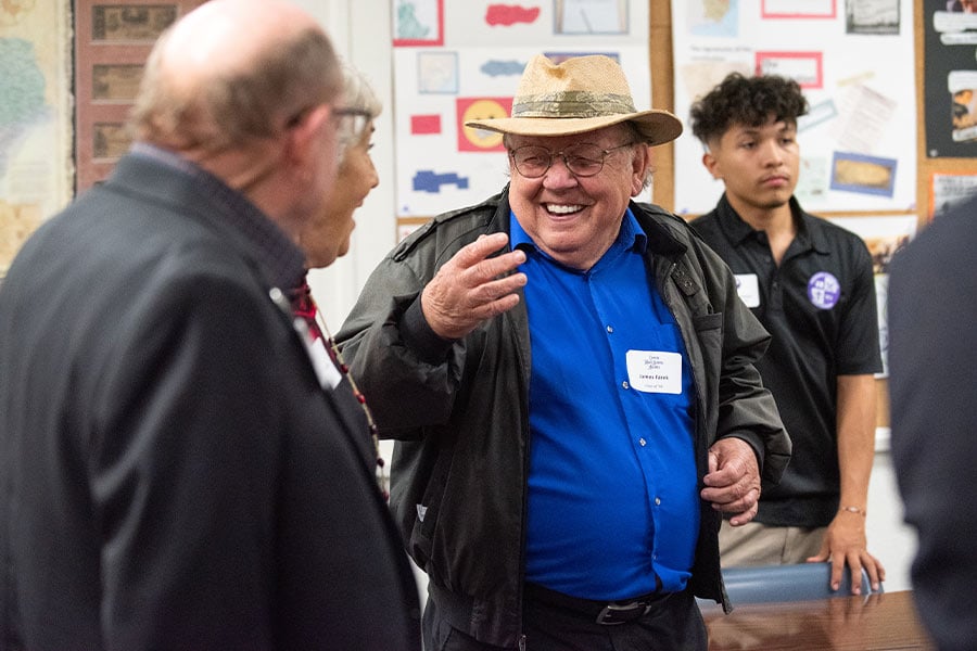 Alumni James Farek, center, of the Class of '56, reacts with laughter while sharing their high school stories during the Laneri High School Alumni tour and fellowship dinner at Cassata High School in Fort Worth, on Nov. 18, 2021. (NTC/Ben Torres)