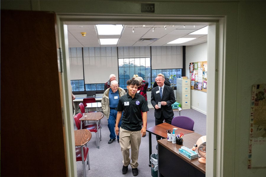 A Cassata High School student leads a tour of his school for alumni of Laneri High School during a tour and fellowship dinner at Cassata High School in Fort Worth, on Nov. 18, 2021. (NTC/Ben Torres)