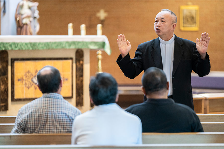 Father Thu Nguyen, diocesan director of Liturgy and Worship, demonstrates the proper positioning of the hands during a practicum on the Rite of Marriage, on Nov. 13, 2021 at St. Peter the Apostle Church in Fort Worth. (NTC/Juan Guajardo)