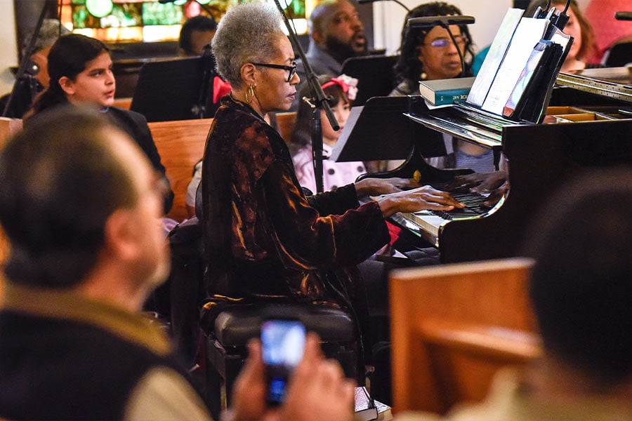 Choir director Zenobia Collins plays the piano during Sunday Mass, on Jan. 26, 2020 at Our Mother of Mercy Parish in Fort Worth. (NTC/Ben Torres)