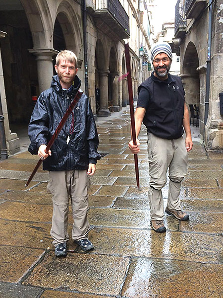 Luke Hutchins and Mark Peredo raise the walking sticks they bought in Santiago de Compostela, Spain.