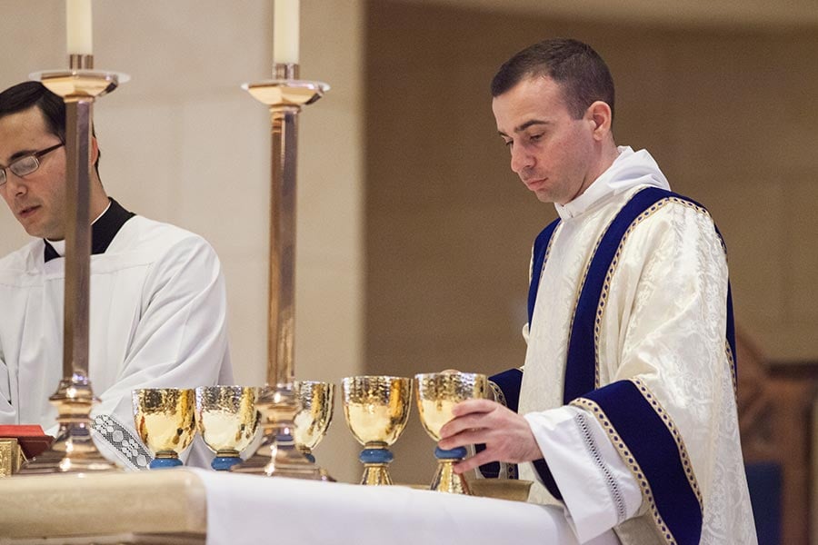 Deacon Maurice Moon prepares for Holy Communion during his transitional diaconate ordination Mass.
