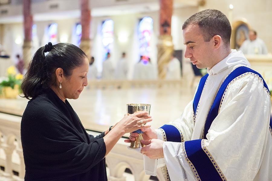Deacon Maurice Moon distributes the Blood of Christ during his transitional diaconate ordination Mass.