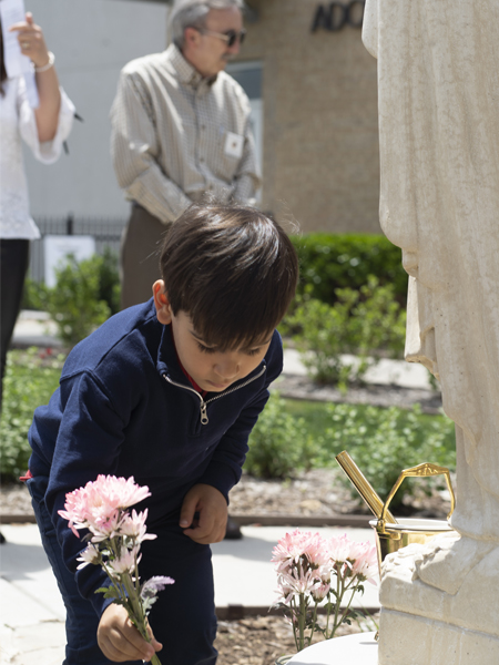 A boy places flowers
