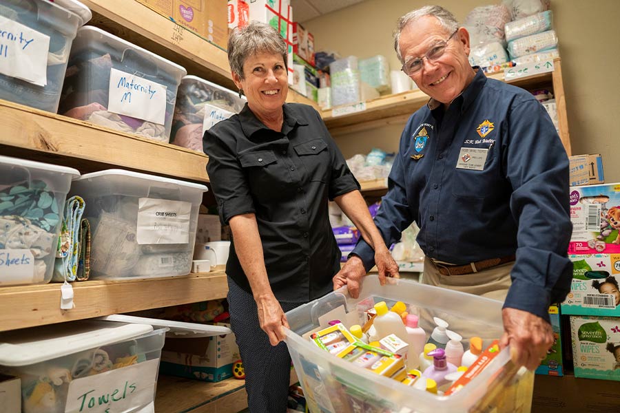 Angela Walters, Gabriel Project coordinator, and her husband, Bob, show off some of the baby items they donate to mothers in need in the Diocese of Fort Worth. (NTC/Juan Guajardo)
