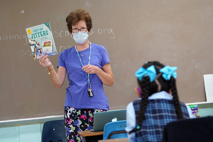 Third-grade teacher Eugenia Hannigan prepares to read a book to her students during the first day of classes at Sts. Cyril & Methodius School in Deer Park, N.Y., Sept. 9, 2020, amid the COVID-19 pandemic. If physical motherhood is giving physical birth, spiritual motherhood is nurturing the soul of the person, as well as mothering those to whom you did not give birth. (CNS photo/Gregory A. Shemitz)