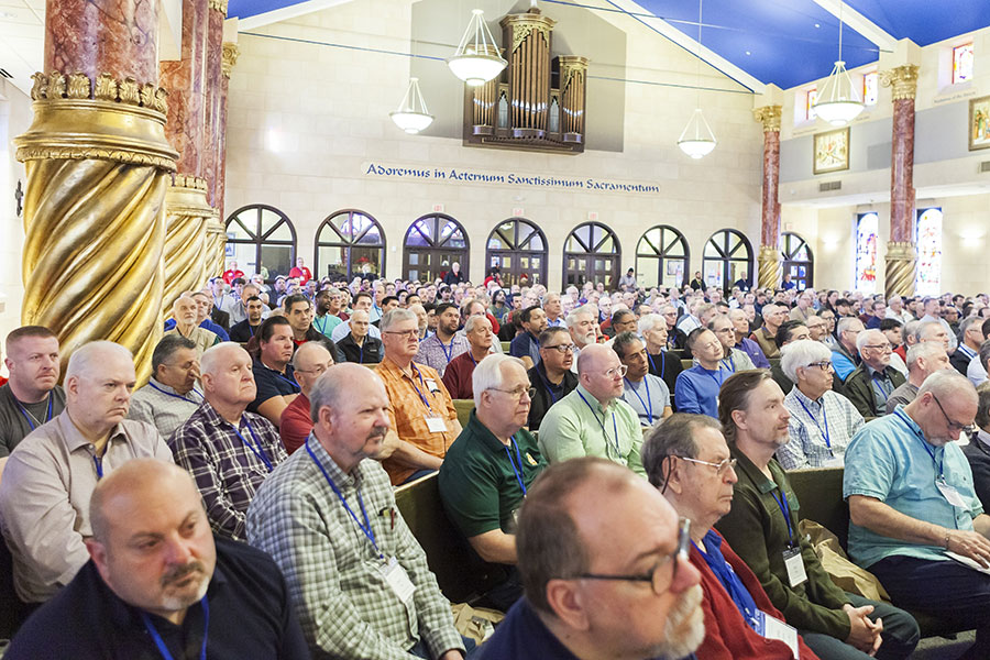 Men sitting in pews