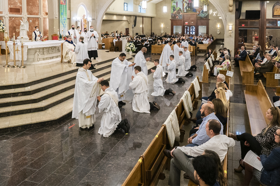 Priests lay hands on the six new priests