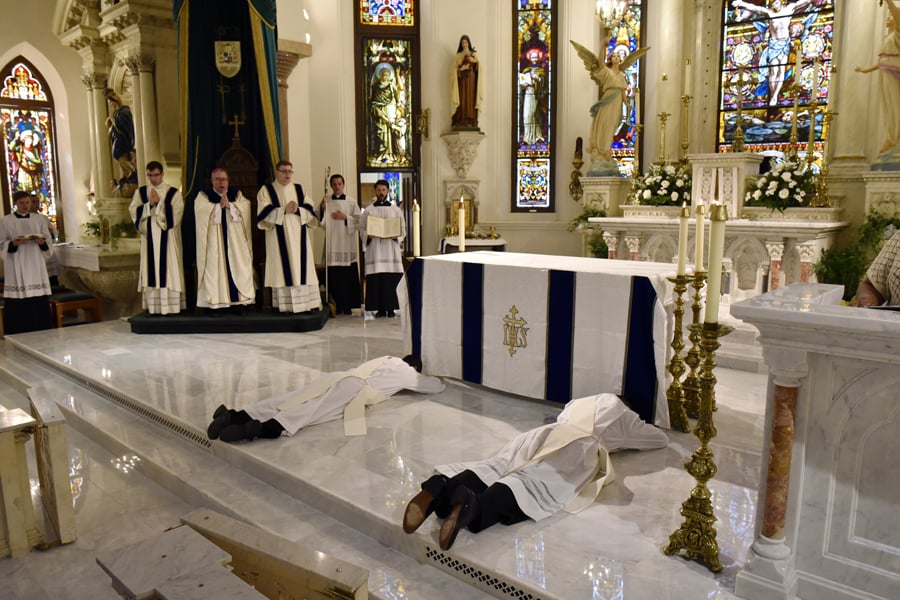 Jonathan Michael Demma and Maurice Lawrence Moon lay prostrate for the Litany of the Saints