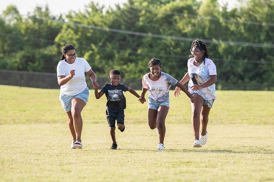Demetria Johnson, a Padua client, plays with her children on July 23, 2021 in Grand Prairie. (NTC/Jayme Donahue)