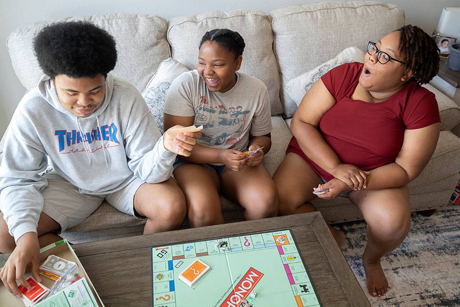 Sheritha Cobb and her son, Devin, and daughter, Cydney, play board games at their home in Cleburne on July 18, 2021. (NTC/Jayme Donahue)