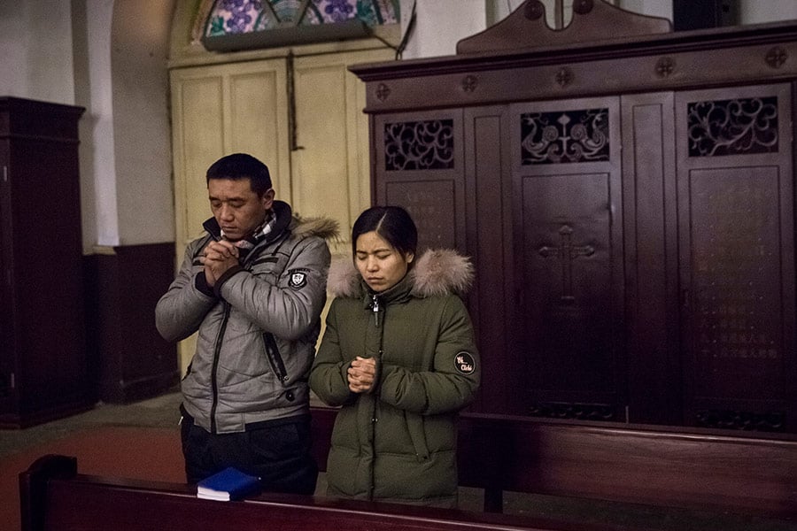 People pray during morning Mass in China (CNS photo/Roman Pilipey, EPA)