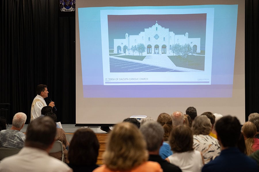 Deacon Zavala shows slide of new parish hall