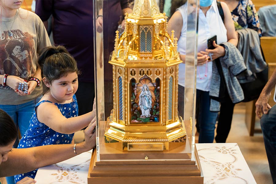 Dora Moralez of Vernon venerates the relics of St. Bernadette on July 21, 2022 at Our Lady of Lourdes Parish in Mineral Wells. (NTC/Juan Guajardo)