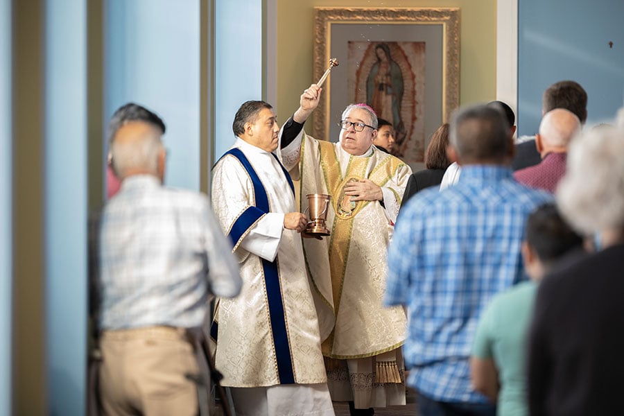 Bishop sprinkles water