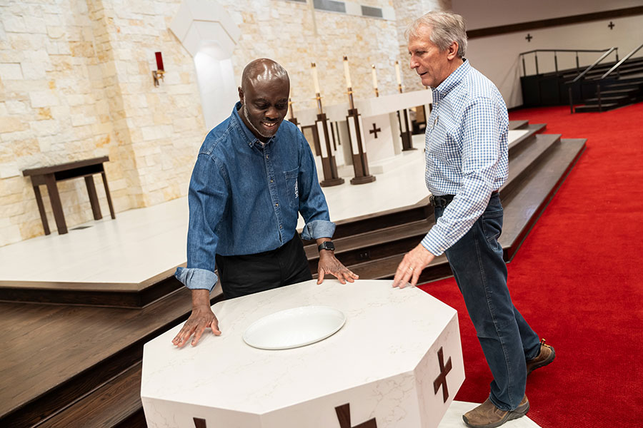 Father Brembah with baptismal font