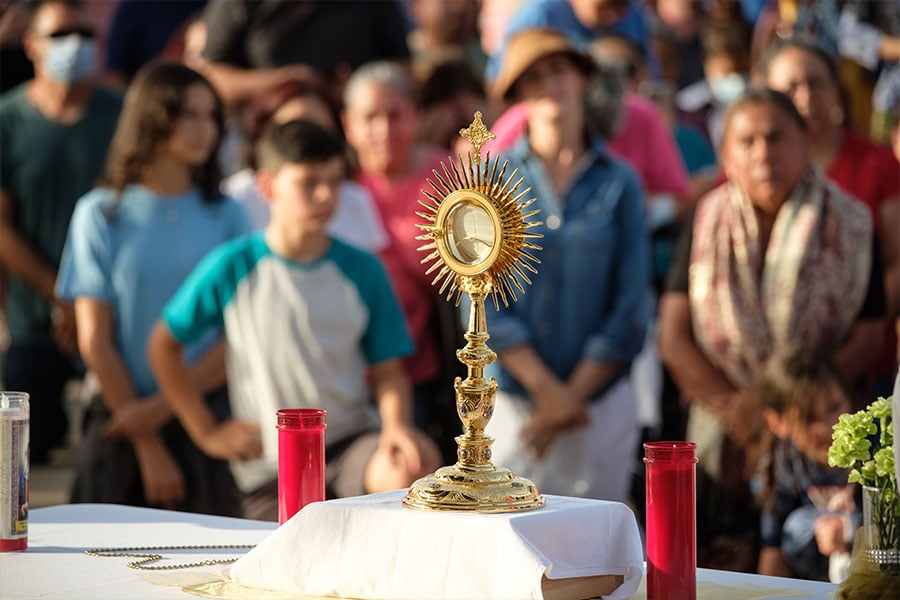 A Eucharistic procession stops at one of the stations during a joint Corpus Christi procession hosted by Immaculate Conception Church, St. John Paul II Parish, and the Loreto House in Denton on Thursday, June 16, 2022. (NTC/Kevin Bartram)