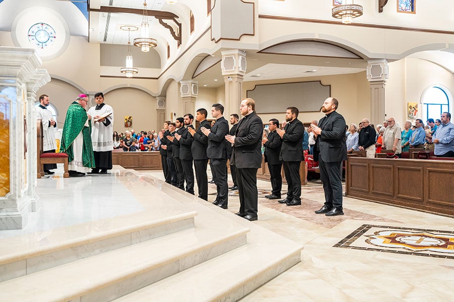 seminarians stand at front of church
