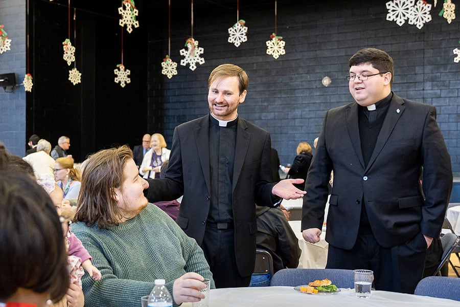 two seminarians chat with parishioners