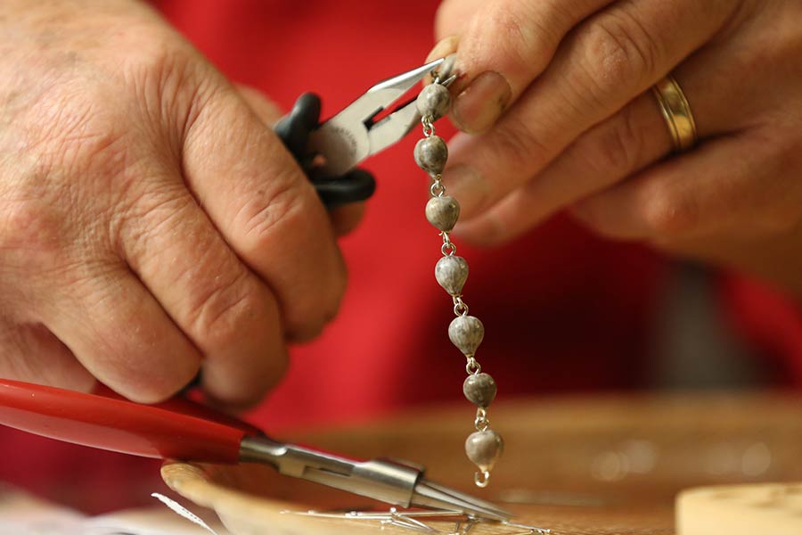 August Bueltel makes rosary beads from his basement.