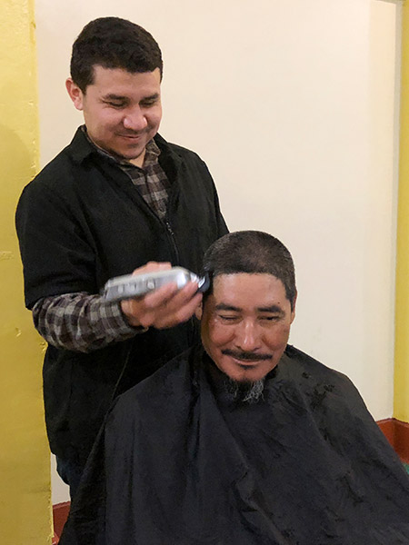 Rudy Romero cuts hair.