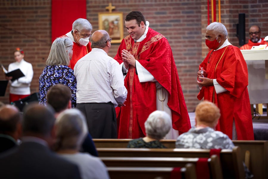 Father Sam Maul blesses his parents during his first Mass at St. Michael Parish in Bedford on May 23, 2021. (NTC/Kevin Bartram)