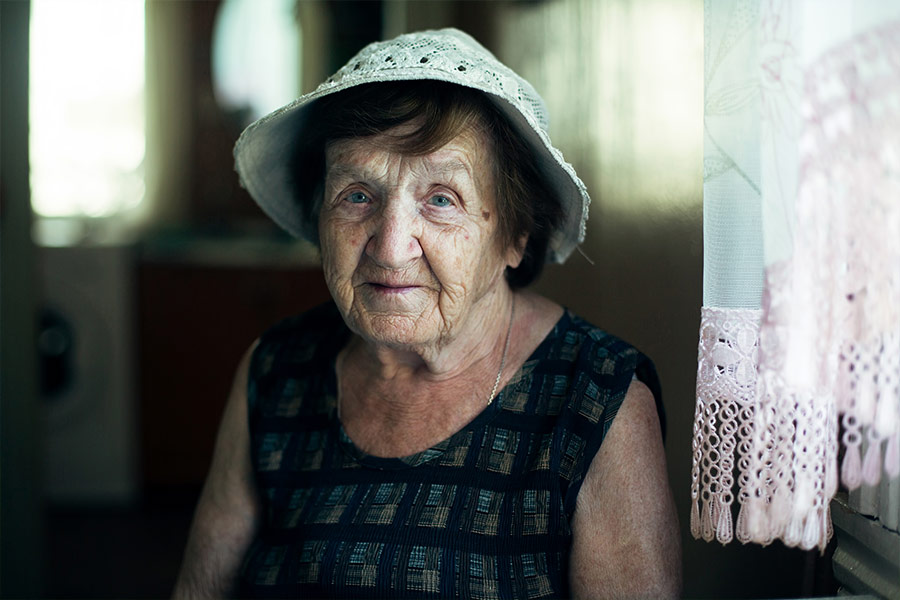 Portrait of an old woman in the kitchen of her house. (Shutterstock/De Visu)