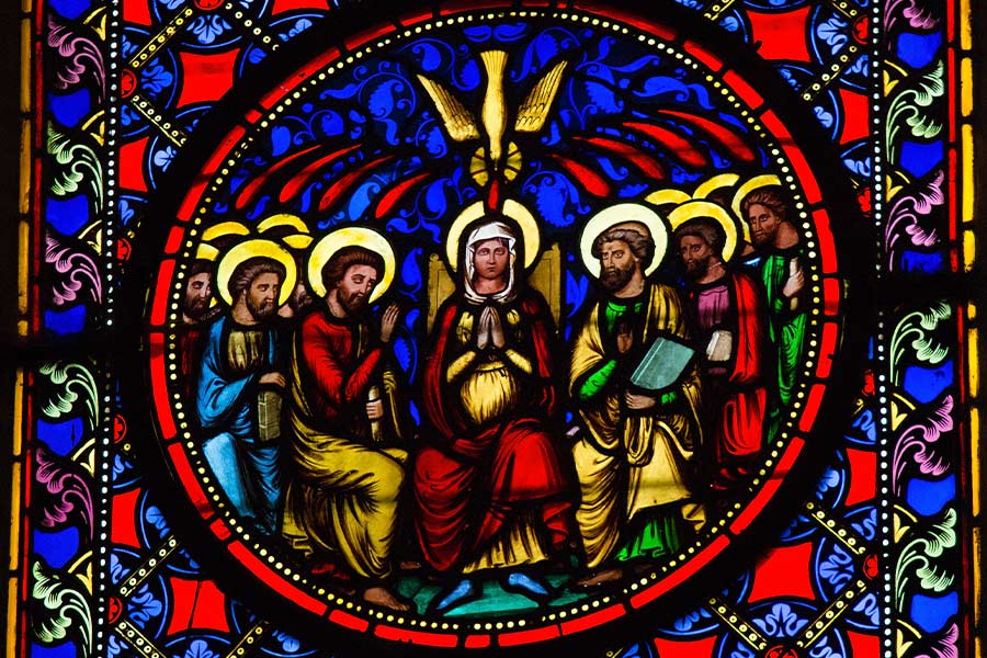 A stained-glass window depicting Pentecost.
