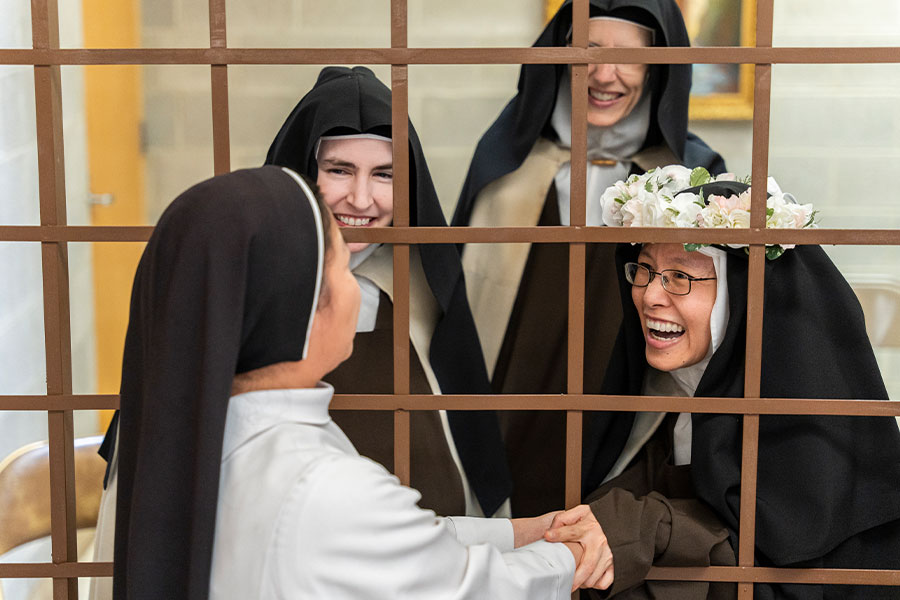 Sister Marie Therese is congratulated by one of her Dominican friends after the profession of solemn vows on May 31, 2022 at Carmel of the Most High Trinity. (NTC/Juan Guajardo)